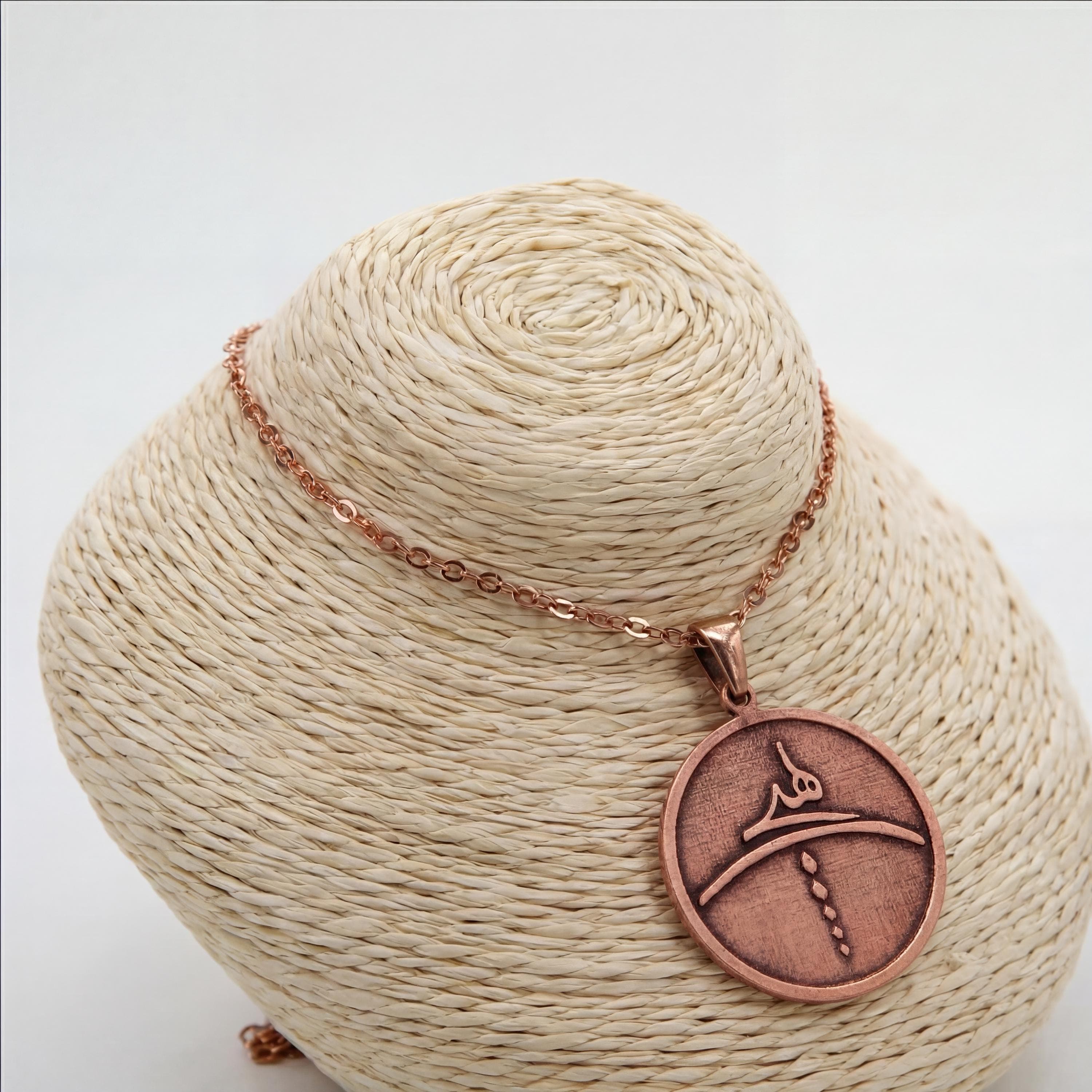 Engraved copper pendant with calligraphy design